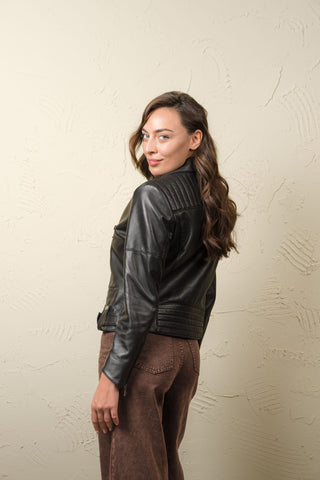 Profile of the Kelly women’s lambskin biker jacket with quilted shoulder panel and belt buckle