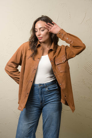 Steve tan nubuck leather shirt jacket with arm raised, showing the double snap cuff