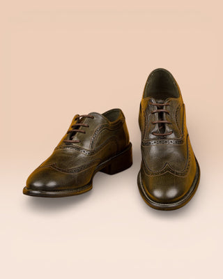 Front and top angled view of a pair of Benheart's DA VINCI leather shoes with wingtip detail, forest green color (BOSCO)