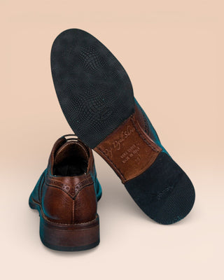 Detail of the Vibram soles on Benheart’s handmade leather shoes, DA VINCI model with wingtip detail, brown color.