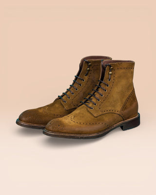 Front angled view of Benheart's Daniel men's cognac suede leather lace-up brogue ankle boots with wingtip design.
