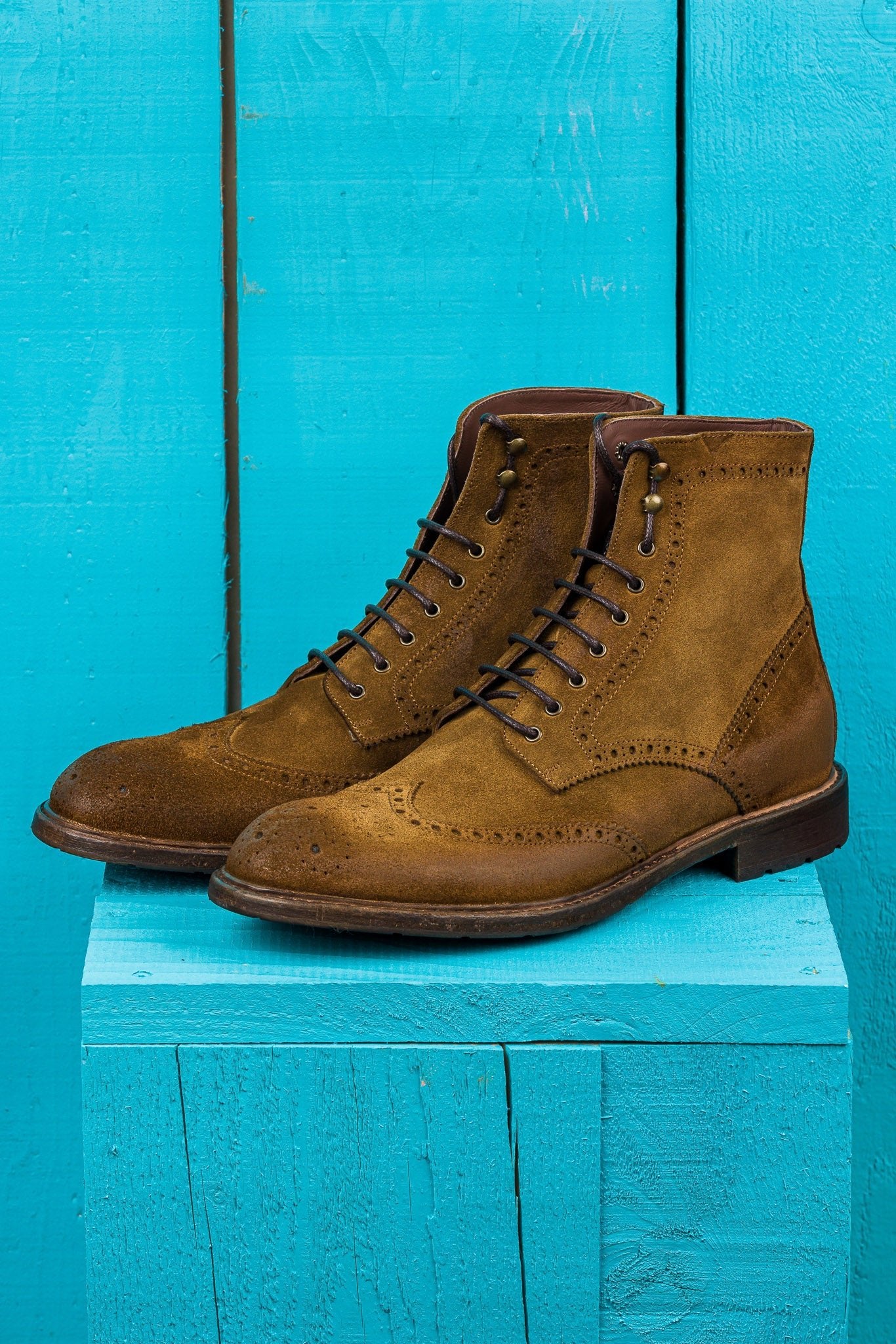 Front angled view of Benheart's Daniel men's cognac suede leather lace-up brogue ankle boots with wingtip design.
