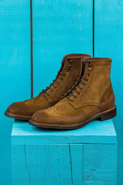 Front angled view of Benheart's Daniel men's cognac suede leather lace-up brogue ankle boots with wingtip design.
