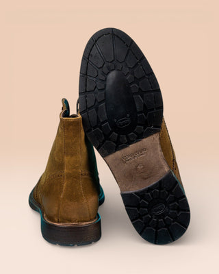 Detail of the Vibram sole of a pair of Benheart Daniel men’s cognac suede lace-up brogue ankle boots with wingtip design