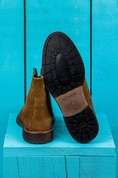 Detail of the Vibram sole of a pair of Benheart Daniel men’s cognac suede lace-up brogue ankle boots with wingtip design