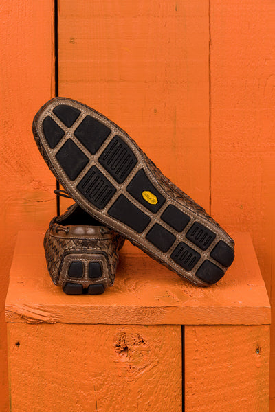 Rear view of Benheart Innocenti E951 woven taupe leather driving moccasins, one showing the heel and the other the Vibram rubber sole.