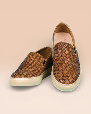 Front angled and top view of Iris unisex woven slip-on shoes in cerro leather with rubber soles.