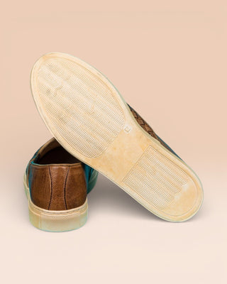 Rear view of Benheart Iris woven cerro leather slip-on shoes, one showing the heel and the other the rubber sole.