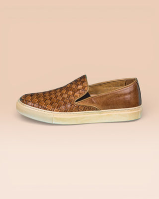 Side view of Iris unisex woven slip-on shoes in cerro leather with rubber soles.