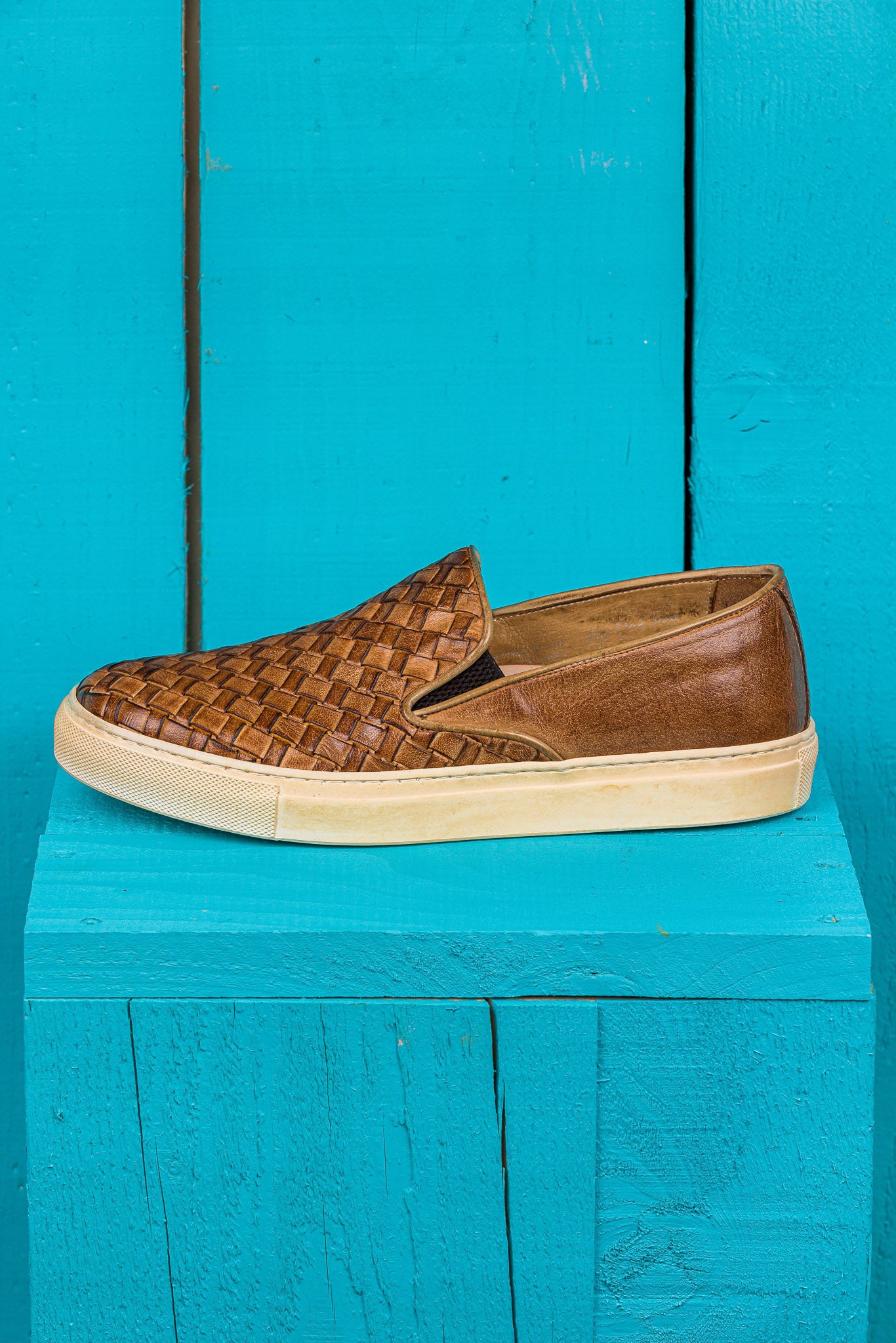 Side view of Iris unisex woven slip-on shoes in cerro leather with rubber soles.