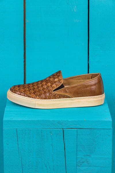 Side view of Iris unisex woven slip-on shoes in cerro leather with rubber soles.