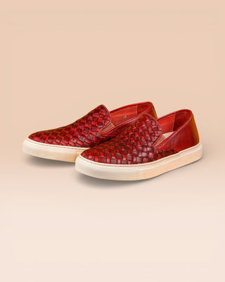 Front angled view of Iris unisex woven slip-on shoes in porpora leather with white rubber soles.