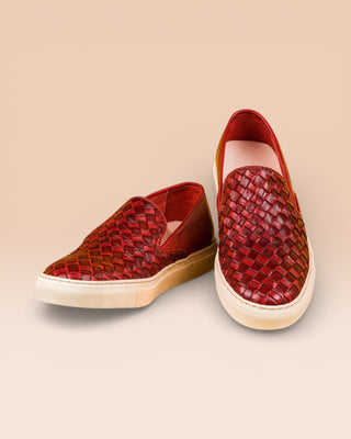 front angled and top view of Iris unisex woven slip-on shoes in porpora leather with white rubber soles.