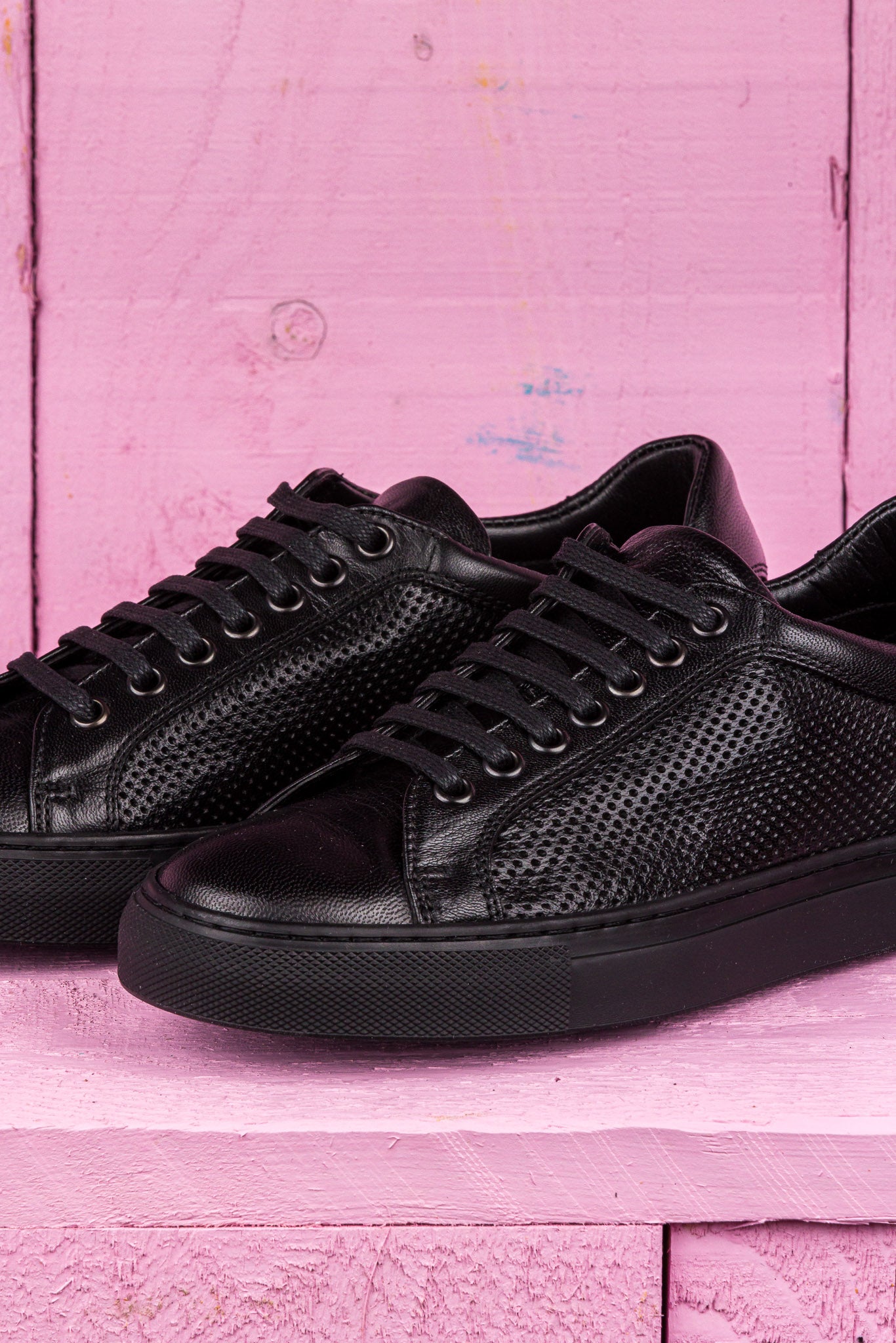 Close up view of Benheart Lario unisex perforated leather sneakers shoes in black color.