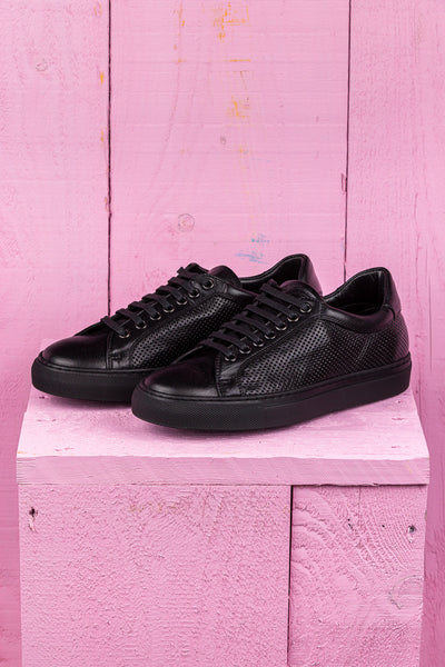 Benheart Lario unisex black perforated leather low-top sneakers, front angled view.