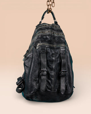 Three-quarter view of the Lorenzo unisex leather backpack in black, showing front pockets and zipper details.