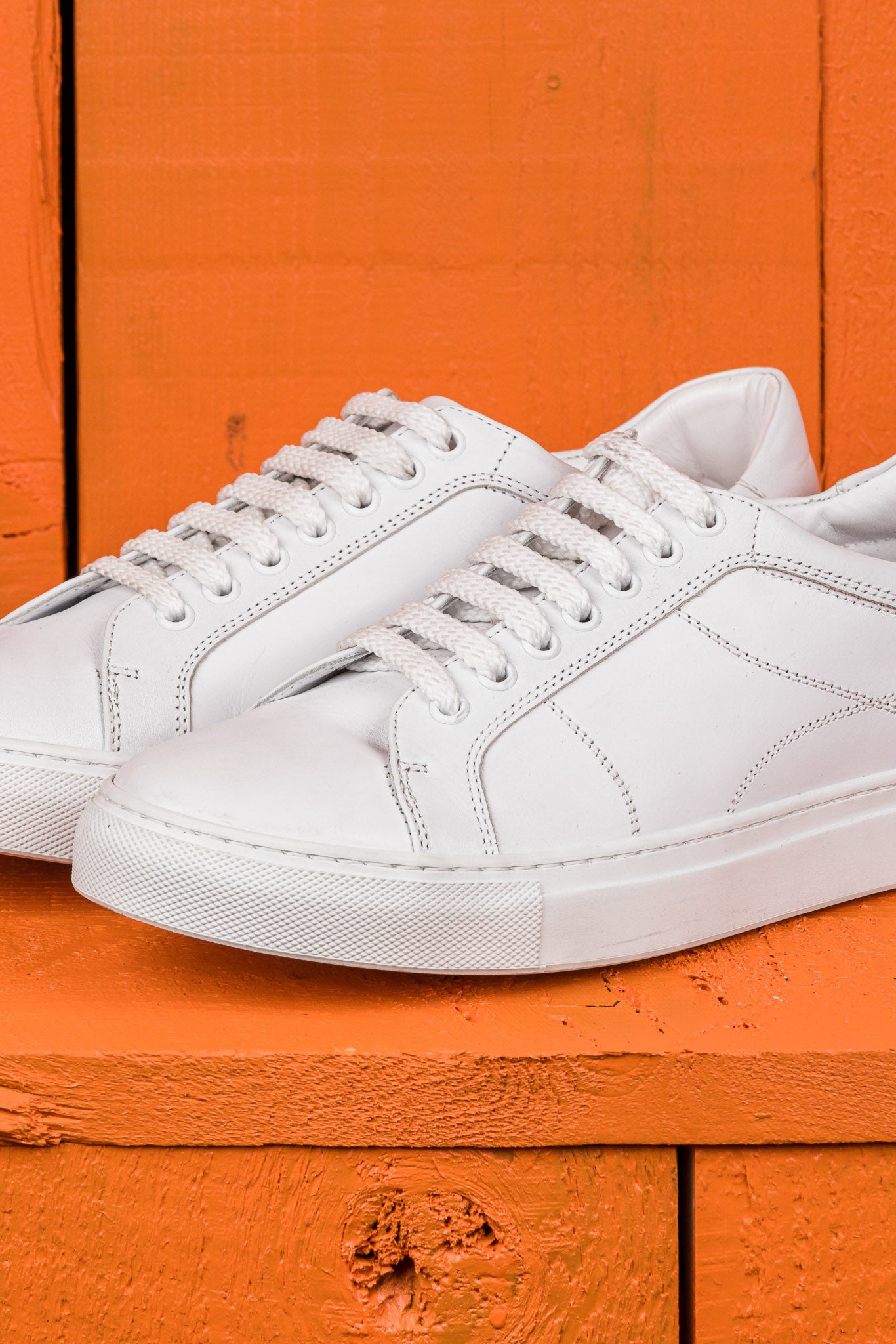 Close up view of Venus unisex white leather sneakers by Benheart, handcrafted in Florence.