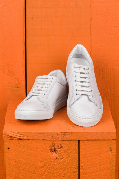 Front angled and top view of Venus unisex white leather sneakers, rubber soles.